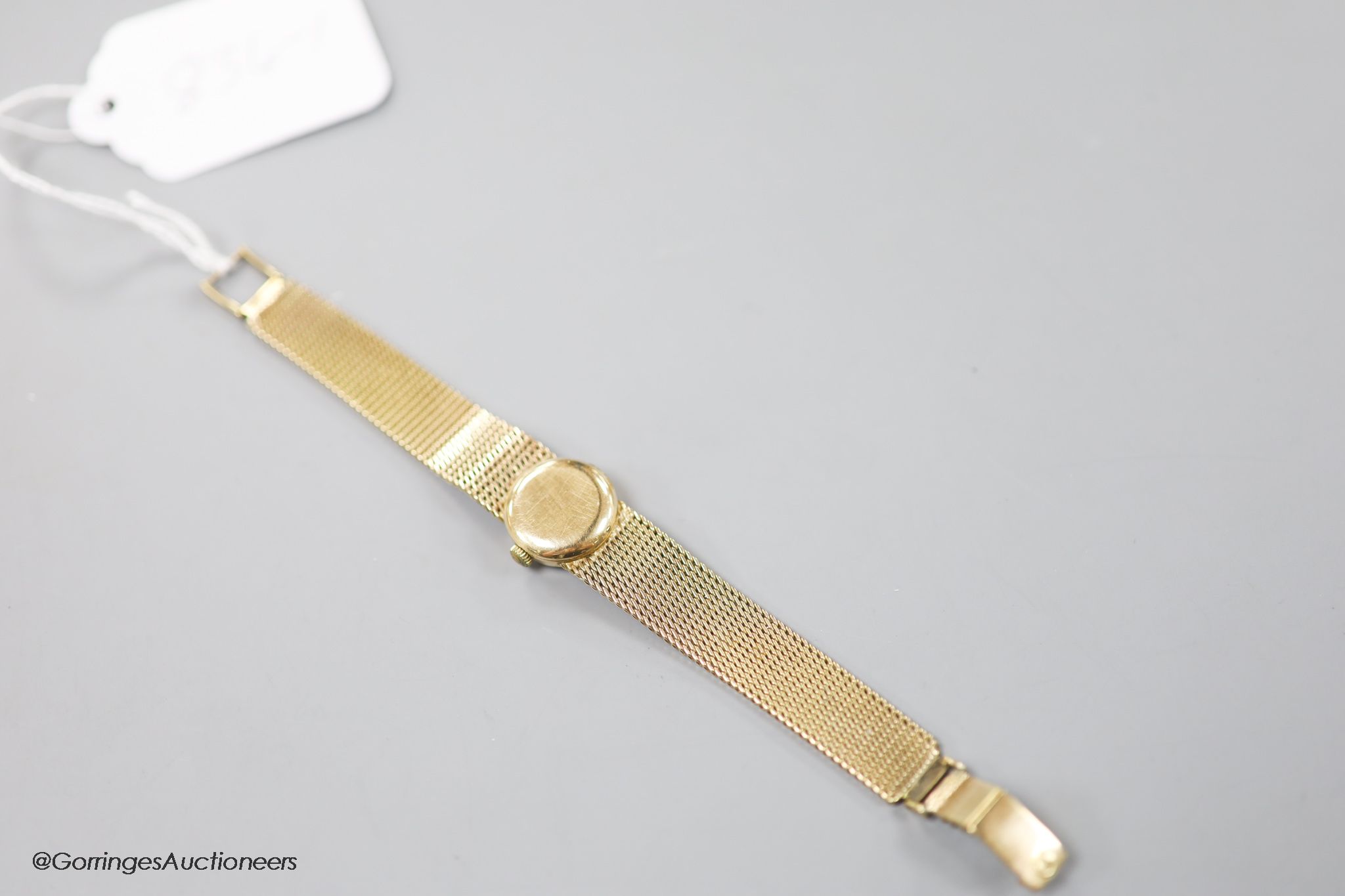 A lady's 9ct gold Omega Ladymatic wrist watch on integral 9ct gold Omega bracelet